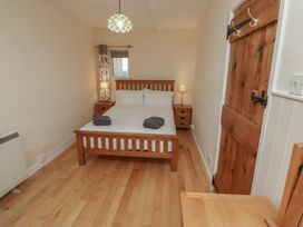 A bedroom with a bed and nightstand at Sunny Brae in Alnwick