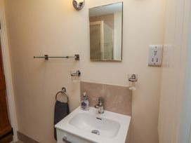 A bathroom with a sink, mirror, and towel holder at Sunny Brae in Alnwick