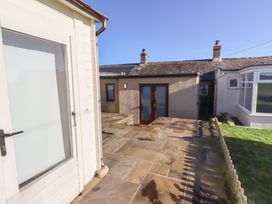 An outdoor area with a patio and grass at 2 Sunny Brae in Embleton