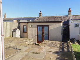 An outdoor view of a house with a patio area at 2 Sunny Brae in Embleton