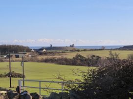 View of fields and distant castle near the sea at 2 Sunny Brae, Embleton