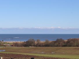 A view of the ocean and landscape at 2 Sunny Brae in Embleton