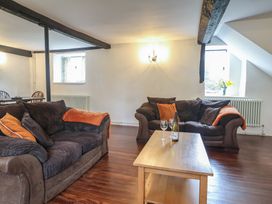 A living room with sofa and coffee table at Manor Cottage Kingstone near Ilminster