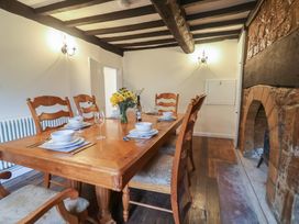 A dining room with a wooden table and chairs at Manor Cottage in Kingstone near Ilminster