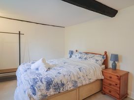 A bedroom with a bed and nightstand at Manor Cottage in Kingstone near Ilminster