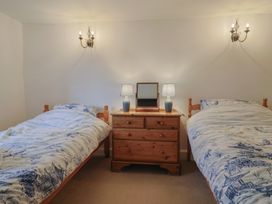 A bedroom with two beds and a chest of drawers at Manor Cottage Kingstone near Ilminster