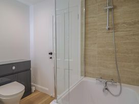A bathroom with a shower and bathtub at Manor Cottage Kingstone near Ilminster