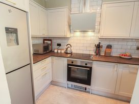 A kitchen with appliances and storage at Tullythwaite Barn in Kendal