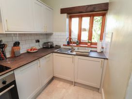 A kitchen with a sink and cabinets at Tullythwaite Barn Kendal