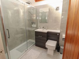 A bathroom with a shower, sink, and toilet at Tullythwaite Barn in Kendal