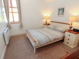 A bedroom with a bed and two nightstands at Tullythwaite Barn in Kendal
