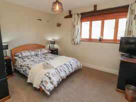 A bedroom with a bed and television at Tullythwaite Barn in Kendal