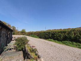 An outdoor area with gravel path and bush at Tullythwaite Barn Kendal