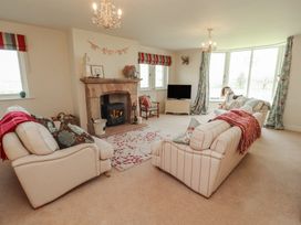 A living room with a fireplace and television at Thimble Hill Near Armathwaite