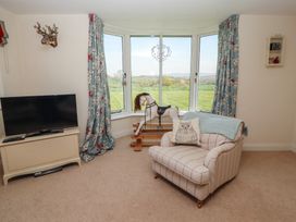A living room with a television and a rocking horse at Thimble Hill Near Armathwaite