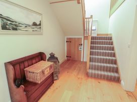 A hallway with stairs and a bench at Thimble Hill Near Armathwaite