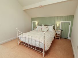 A bedroom with a bed and bedside table at Thimble Hill Near Armathwaite