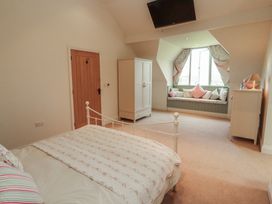 A bedroom with a bed and a wardrobe at Thimble Hill Near Armathwaite