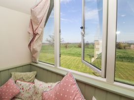 A snug with cushions and a window showing views at Thimble Hill near Armathwaite