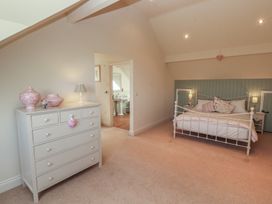 A bedroom with a bed and dresser at Thimble Hill Near Armathwaite