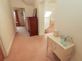 A hallway with a staircase and furniture at Thimble Hill near Armathwaite