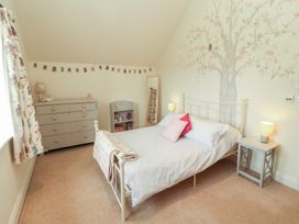 A bedroom with a bed and dresser at Thimble Hill near Armathwaite