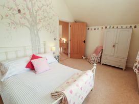 A bedroom with a bed and wardrobe at Thimble Hill Near Armathwaite