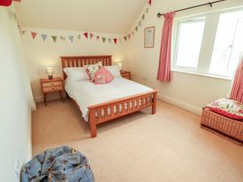 A bedroom with a bed and bedside tables at Thimble Hill Near Armathwaite