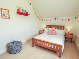 A bedroom with a bed and nightstands at Thimble Hill Near Armathwaite