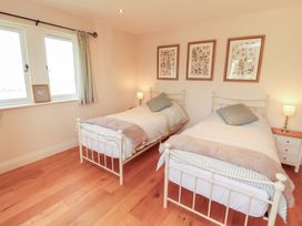 A bedroom with two beds and windows at Thimble Hill Near Armathwaite