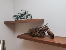 Two motorcycle models displayed on a wooden shelf at 1 Sunnybrae Alnwick