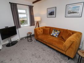 A living room with a TV, sofa and lamp at 1 Sunnybrae Alnwick