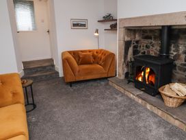 A living room with a fireplace and a sofa at 1 Sunnybrae in Alnwick