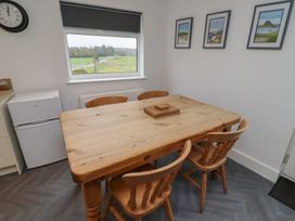 A dining room with a wooden table and chairs at 1 Sunnybrae in Alnwick