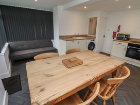 A kitchen with a dining table and chairs at 1 Sunnybrae in Alnwick