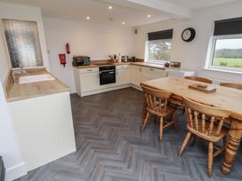 A kitchen with a table and chairs at 1 Sunnybrae in Alnwick