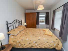 A bedroom with a bed, wardrobe, and window at 1 Sunnybrae in Alnwick