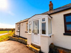 A front porch with a door and windows at 1 Sunny Brae in Embleton