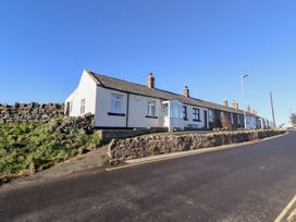 A row of houses on a street at Harry's Cottage in Embleton
