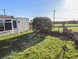A garden with a bush and grass at Harry's Cottage in Embleton