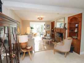 A living room with a sofa and fireplace at The Music Box Beaumaris