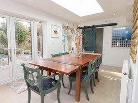 A dining room with a table and chairs at The Music Box in Beaumaris