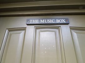 A door with a sign reading The Music Box at The Music Box in Beaumaris