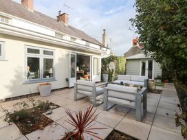 An outdoor patio with seating and plants at The Music Box in Beaumaris