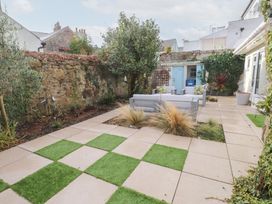 A garden with seating area and plants at The Music Box in Beaumaris