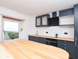 A kitchen with a sink and cabinets at Boscabrea near Tintagel