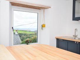 A kitchen with a window and a countertop at Boscabrea near Tintagel