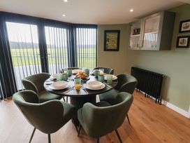 A dining room with a round table and chairs at Unit 1 in Ipswich