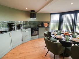 A kitchen with a dining area and appliances at Unit 1 in Ipswich