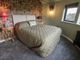 A bedroom with a bed and lamp at Unit 1 in Ipswich